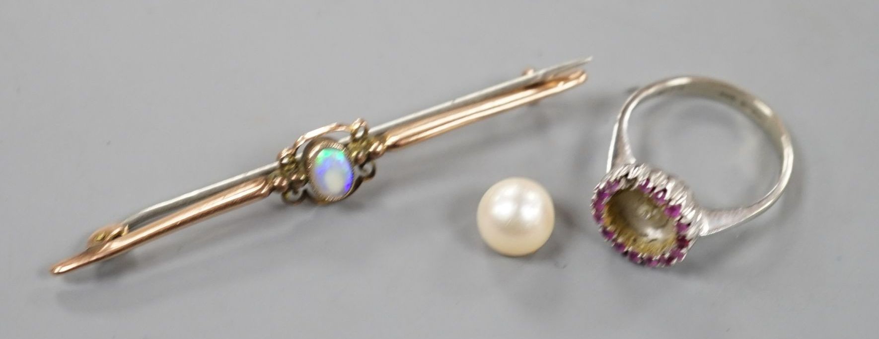A modern Italian 18ct white gold, cultured pearl and ruby cluster set dress ring (pearl loose and missing one ruby), size N, gross 3.9 grams and a 9ct and white opal set bar brooch, gross 2.2 grams.